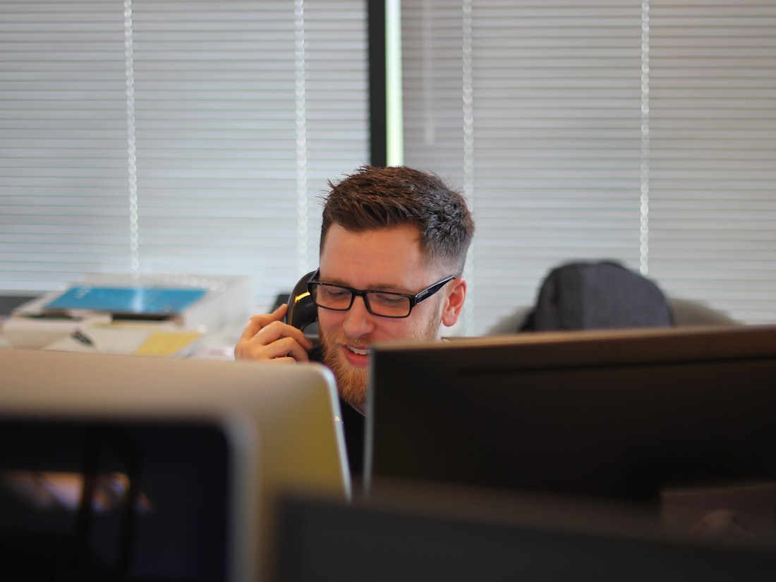 Business professional answering a customer call in the office